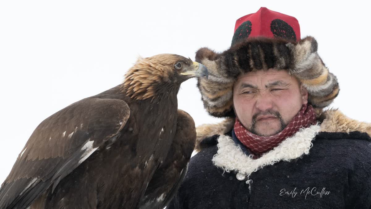 A Kazakh eagle hunter face to face with his golden eagle